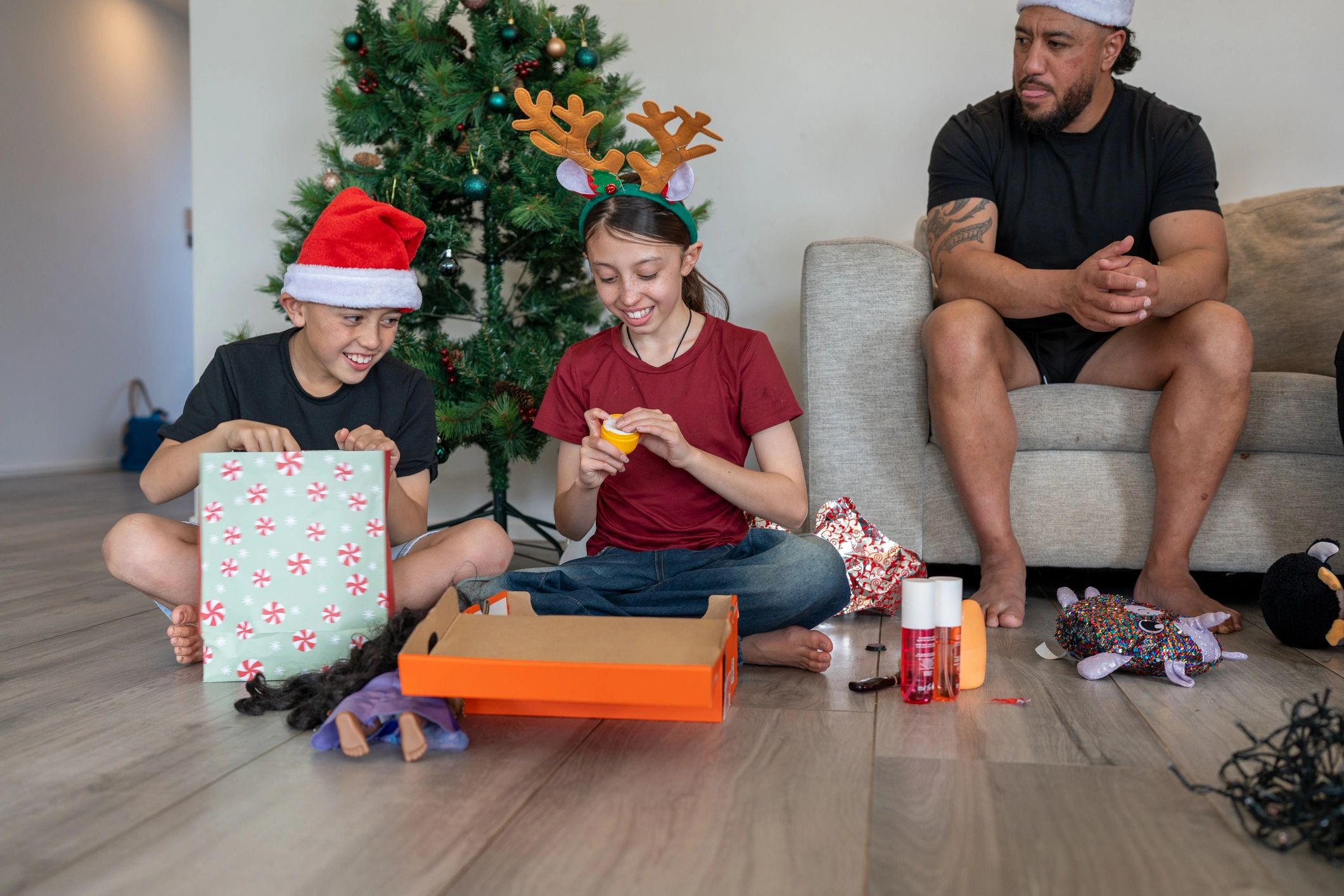 Kids opening Christmas presents with excitement